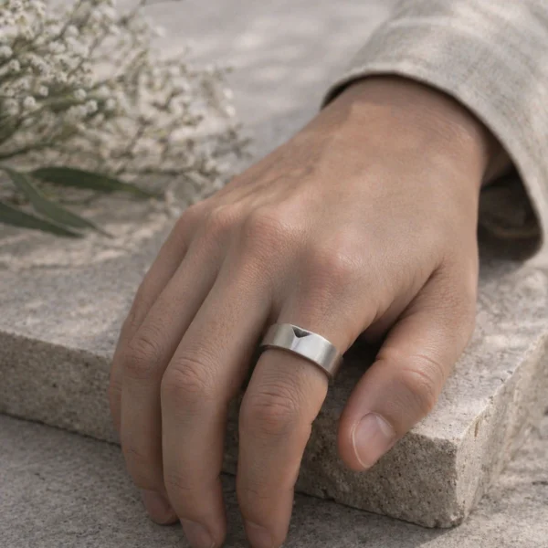 Minimalist silver ring on hand with geometric design and soft natural lighting