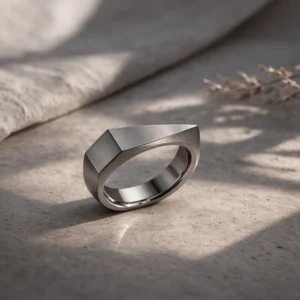 Geomtric silver ring on a stone table background